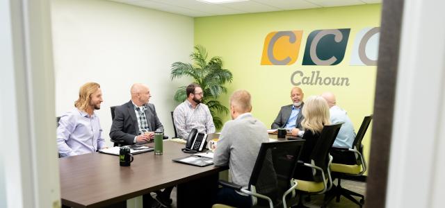 A group of people sitting at a conference table